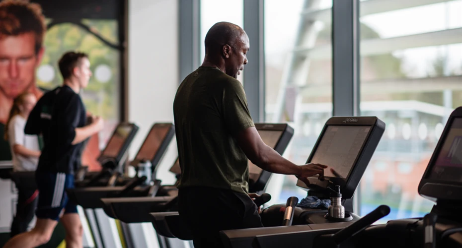 A member of the gym using a treadmill.