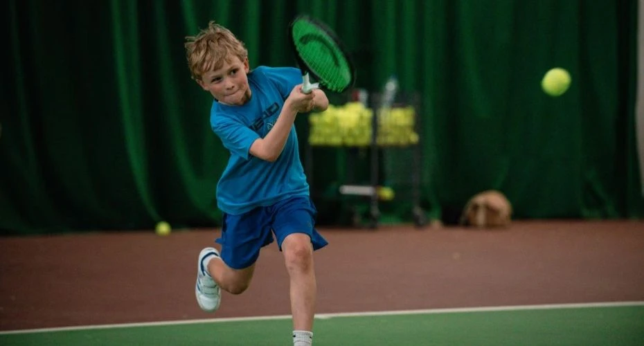 A child playing tennis at Exeter Tennis Centre.