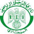 الشعار القديم للنادي والذي ظلت أقمصة الفريق تحمله مدة 53 سنة، أي منذ نشأته سنة 1949 قبل أن يتم تغييره سنة 2001، يُعتقَد أن مصمم الشعار هو الأب جيكو بنفسه الذي حرص على جعل النسر الجارح شعارا للنادي.