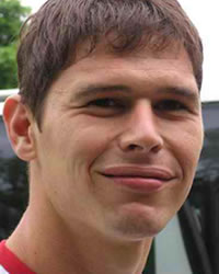 Head of young white man smiling.