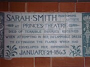 A tablet formed of six standard sized tiles, bordered by green flowers in the style of the Arts and Crafts movement