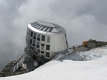 Vue en contre-plongée d'un refuge ovoïde et métallique.