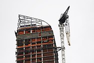 Dangling construction crane at the top of the building on the day after Hurricane Sandy