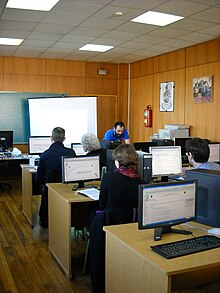 People sitting at computers in a computer lab