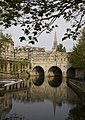 An English 18th century example of an arch bridge in the Palladian style, with shops on the span: Pulteney Bridge, Bath