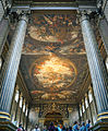 The Painted Hall at the Old Royal Naval College in Greenwich, London, England, designed by Sir Christopher Wren and Nicholas Hawksmoor. The paintings by Sir James Thornhill comprise architectural trompe-l'œil; for instance, the Corinthian columns look fluted whilst the far wall depicts pilasters and an entablature. In practice none of these elements exist in the third dimension