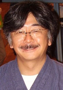 A smiling middle-aged man in blue clothing