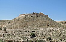 A ruined castle built of stones on a hill