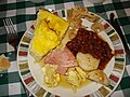 Breakfast at a sugar shack, featuring fève au lard, oreilles de crisse, eggs, ham and potatoes.