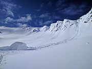 A piece of snow cornice which has fallen off a ridge in early spring