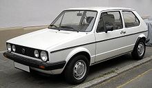 White hatchback car with quad headlights.