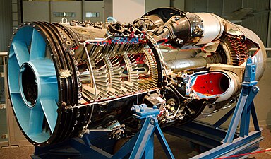 Rolls-Royce Avon early jet engine showing 1 of 2 sets of 3 valves at the top and 1 of 2 valves at the bottom which release some air from the compressor, pressure ratio 7.45:1, for starting and low speed running. Also visible at the front is the row of bearings for the variable inlet guide vanes.[61]