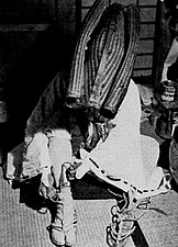 A pilgrim performing kaihōgyō laces waraji over tabi, 1954