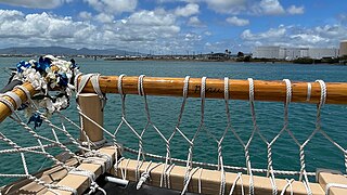 Mau's name carved into the rail at the navigator's seat on the port rear quarter of Hōkūle'a