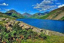 Blue lake between green hills.