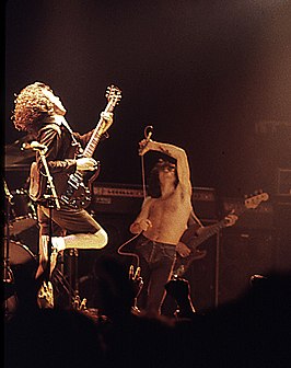 Angus Young en Bon Scott van AC/DC tijdens een concert in de Ulsterhall te Belfast in 1976