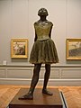 Little Dancer of Fourteen Years, cast in 1922 from a mixed-media sculpture modeled ca. 1879–80, Bronze, partly tinted, with cotton skirt and satin hair ribbon, on a wooden base, Metropolitan Museum of Art