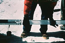 An ice core being slid out of a drill barrel sideways