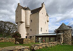 Photograph showing the main castle, the conservatory, and some of the garden.