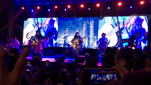 A wide angle shot of musicians performing onstage