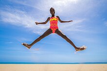 Girl wearing a pink and orange swimsuit