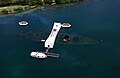 Aerial photograph of the sunken USS Arizona and the USS Arizona Memorial.