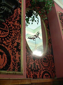 Interior detail of a Tad's, showing textured black-and-red wallpaper with the "T" motif