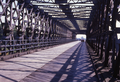 Through truss bridge with steel girders and wooden carriageway