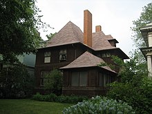 Exterior view of the Geoarge W. Smith house from right front corner to demonstrate a similar porch design and main house massing to the Hills House. The Smith house has the same roof, but its eaves are shallower and flared ends are less pronounced.