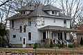 Image 7A wood-frame American Foursquare house in Minnesota with dormer windows on each side and a large front porch