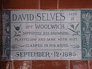 A tablet formed of six standard sized tiles, bordered by green flowers in the style of the Arts and Crafts movement