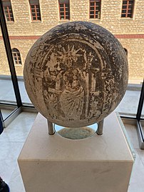 A magic sphere depicting Helios seated below an arch with a whip in one hand and three torches in the other. Seated next to Helios are two dogs which may represent Sirius and Procyon. 2nd–3rd century AD.