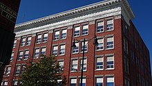 Exterior of building red bricks with white trim around windows constructed in Edwardian architecture