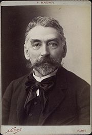 head and shoulders photograph of middle-aged white man with neat beard full head of greying hair