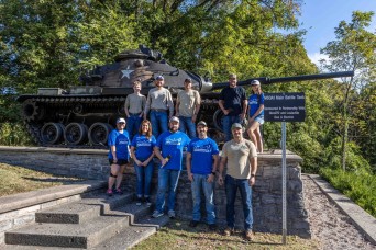 LG&E Volunteers paint main battle tank for annual day of giving