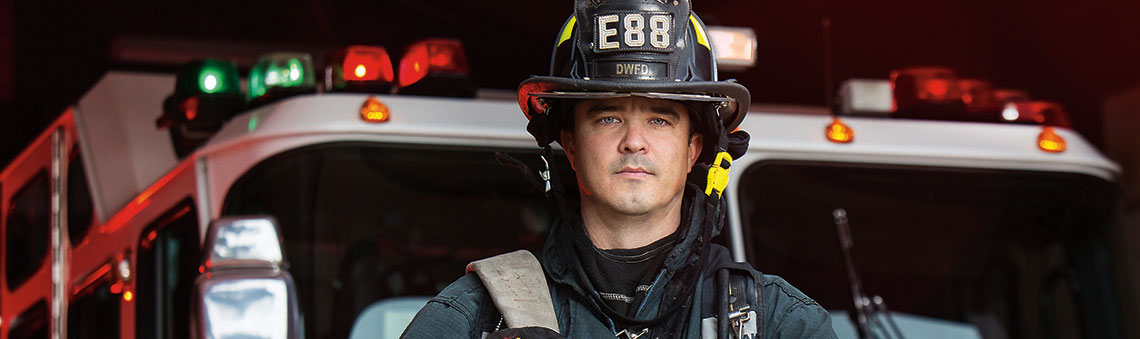 fire fighter in front of rig