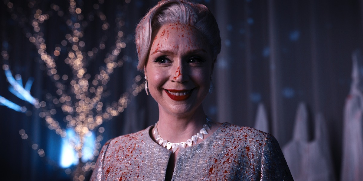 Gwendoline Christie smiling with her face covered in blood.