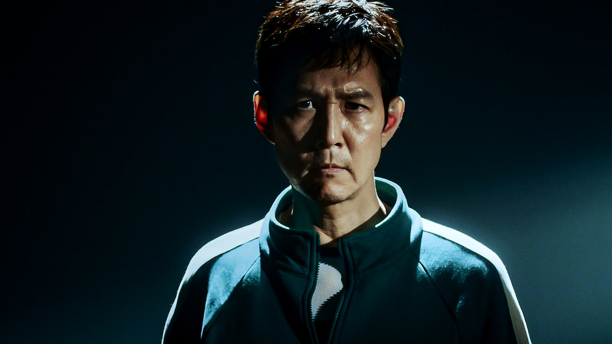 Lee Jung-jae as Seong Gi-hun stands wearing a green jumpsuit in Season 2 of 'Squid Game'