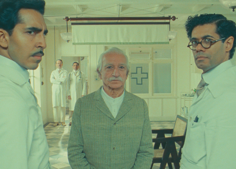 Dev Patel as Dr. Chatterjee, Ben Kingsley as Imdad Khan, and Richard Ayoade as Dr. Marshall in 'The Wonderful Henry Sugar.'