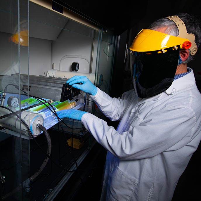 Jack Koziel works with ultraviolet light equipment in his lab