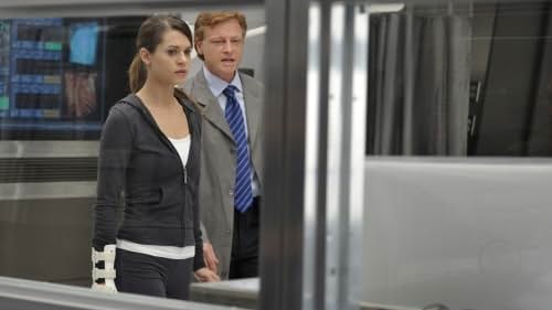 Patrick Garrow and Lyndsy Fonseca in Nikita (2010)