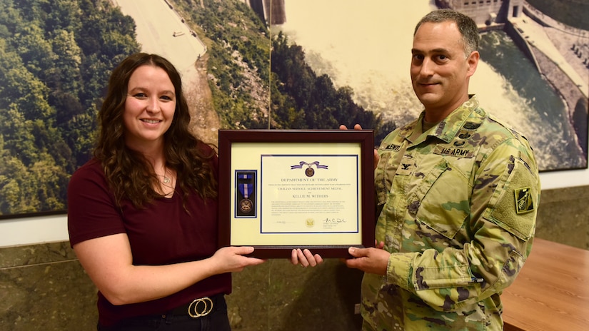 Col. Phillip J. Valenti, U.S. Army Corps of Engineers Great Lakes and Ohio River Division deputy commander, presents the Department of the Army Achievement Award for Civilian Service to Kellie Withers, administrative assistant in the USACE Nashville District, during a ceremony Aug. 22, 2024, at Center Hill Dam in Lancaster, Tennessee. (USACE Photo by Lee Roberts)