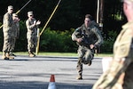 Sgt. Carter Cooper, an 11B infantryman assigned to the Virginia National Guard, completes the final 12-mile ruck march at the Army National Guard’s 2024 Best Warrior Competition, a 12-mille ruck march, Aug. 8, 2024, at the Ethan Allen Firing Range, near Jericho, Vermont. For five days, the top National Guard Soldiers and noncommissioned officers in the nation faced a series of rigorous challenges, including multiple ruck marches, weapons proficiency tests and a modified biathlon. The top competitors will go on to represent the Army National Guard in the Department of the Army Best Squad Competition. (U.S. Army National Guard photo by Sgt. 1st Class Terra C. Gatti)