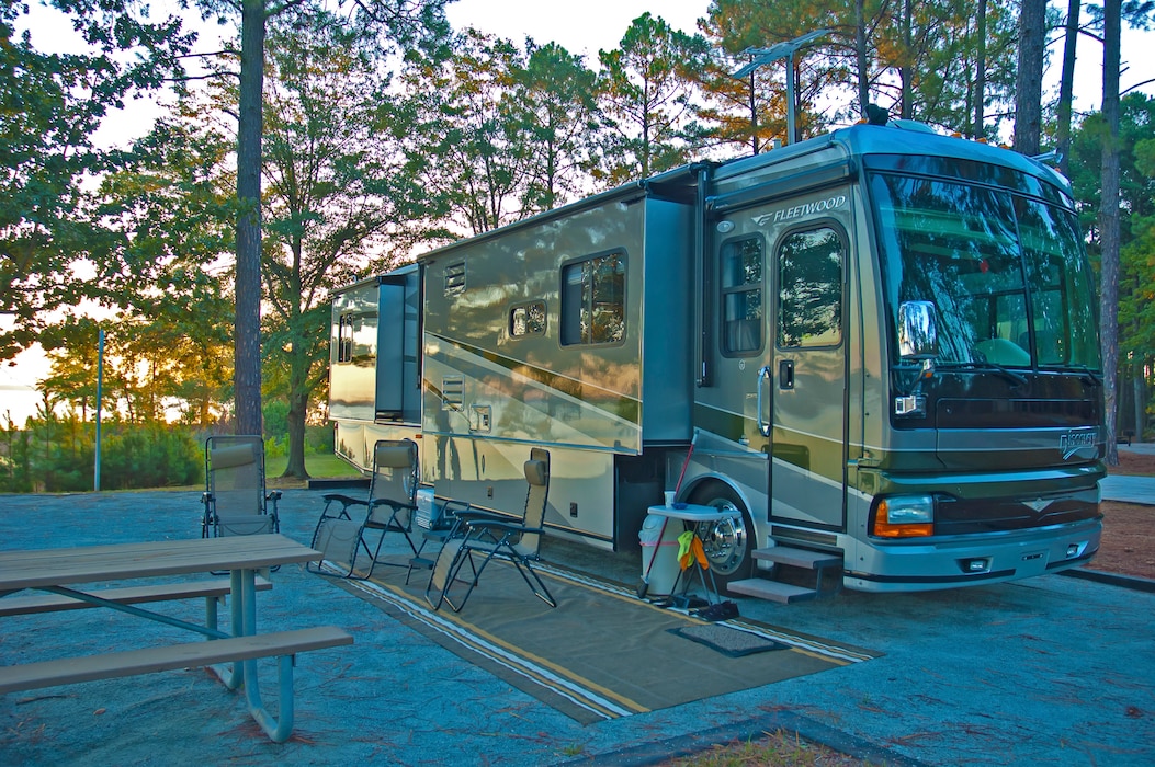 An RV parked by a lake