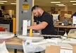 A biomedical equipment technician works on a medical device at the U.S. Army Medical Materiel Agency’s Medical Maintenance Operations Division at Hill Air Force Base, Utah. (C.J. Lovelace)