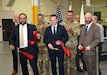 Leaders from the U.S. Army Medical Materiel Agency, U.S. Army Medical Logistics Command and Tobyhanna Army Depot cut a ribbon May 2 to celebrate a modernization project for USAMMA’s Medical Maintenance Operations Division at the installation in Pennsylvania. Pictured, from left, are Jorge Magana-Cortez, director of USAMMA’s Medical Maintenance Management Directorate; William Wall, MMOD-PA interim director; and Robert A. Lantka II, deputy to the commander, Tobyhanna Army Depot. (Photo Credit: C.J. Lovelace)