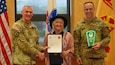 Kimberly Cooper, wife of U.S. Army Medical Materiel Agency Commander Col. Gary Cooper, was named one of Fort Detrick’s three Volunteers of the Year in a ceremony April 18. Cooper is pictured with Brig. Gen. Edward Bailey, left, commanding general of U.S. Army Medical Research and Development Command and Fort Detrick, and Command Sgt. Maj. Kyle Brunell. (U.S. Army photo by Samuel Mensah/USAMRDC)