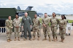 U.S. Air Force Maj. Gen. Duke Pirak, right, Air National Guard deputy director, poses for a group photo after touring the new Expandable Single Pallet Expeditionary Kitchen with members from the 192nd Wing, Virginia ANG and the 127th Wing, Michigan ANG during the cookies for delegates event Sept. 6, 2024, at Joint Base Andrews, Maryland. The rapid-deployable E-SPEK enables services members to feed personnel in various field conditions from domestic operations to deployed environments, including remote and austere locations. (U.S. Air National Guard photo by Master Sgt. Eugene Silvers)