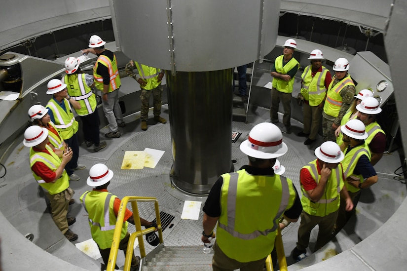 U.S. Army Engineer Research and Development Center (ERDC) Board of Directors take a close up look at a hydropower turbine shaft at the Barkley Dam hydropower facility in Grand Rivers, Ky. during a visit on Sept. 23, 2024. The visit aimed to explore opportunities for innovation and collaboration between ERDC and USACE Nashville District at key projects. (USACE Photo by Michael Davis)