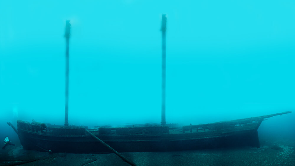 Side view of a ship resting up right on the sea floor